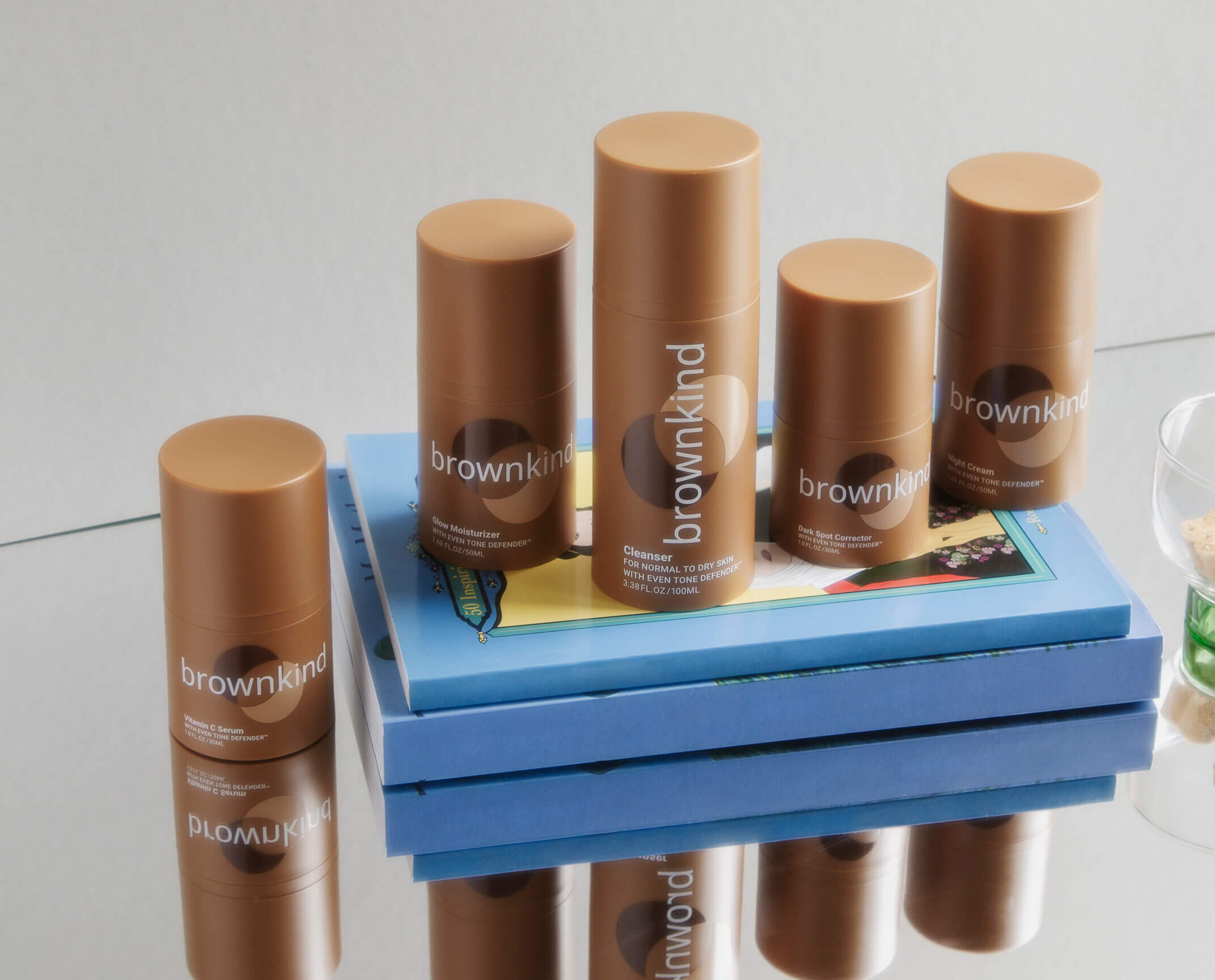 Image of brownkind bottles on a stack of books