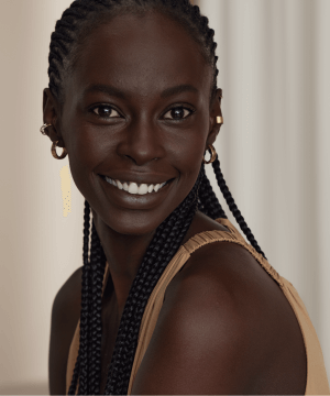 A portrait of a woman with braids smiling 